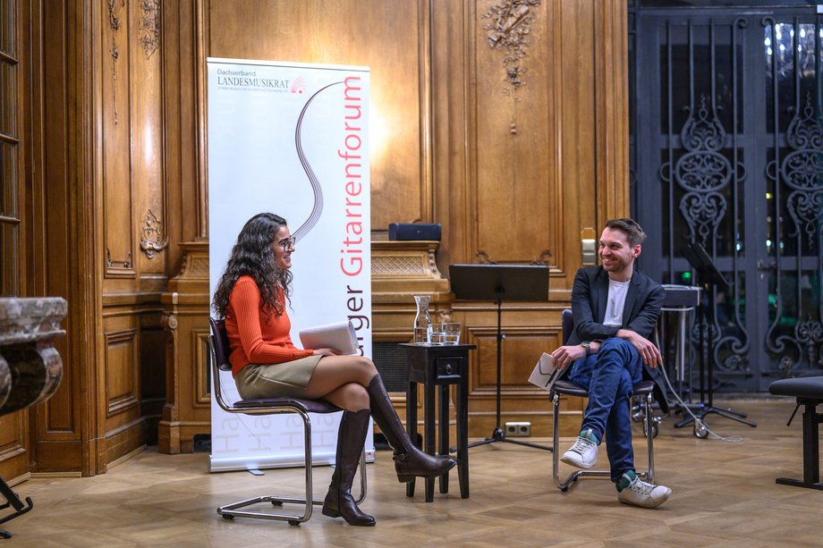Two people sitting on chairs during an interview