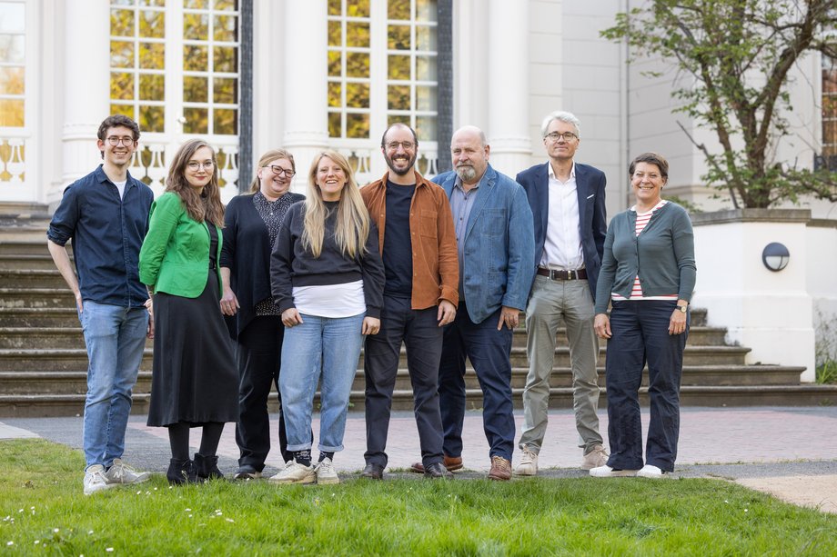 Fachgruppe Musikwissenschaft mehrere Personen stehen vor einer weißen Villa im Garten